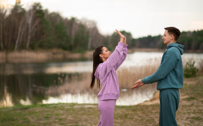 a man and woman standing near water becoming healthy practicing gratitude